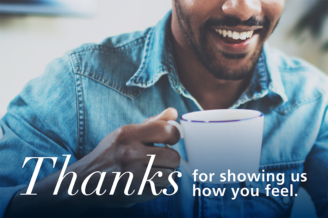 Close up of man holding coffee mug with text below saying "Thanks for showing us how you feel.".