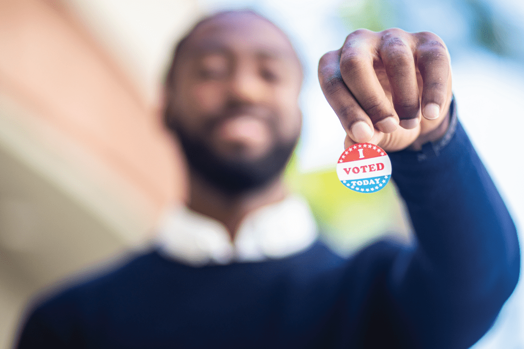 Man holding a voting sticker