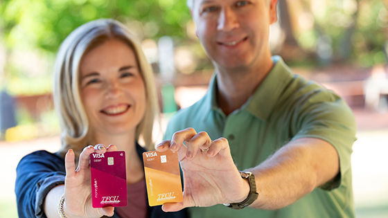 Couple holding up MoneyPlus cards