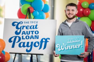 Young man holding a winner's sign.