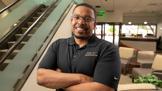 A TFCU employee smiling and looking at the camera.