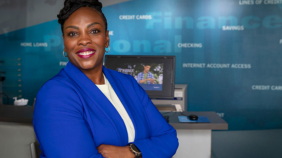 A woman who is a TFCU employee smiling at the camera