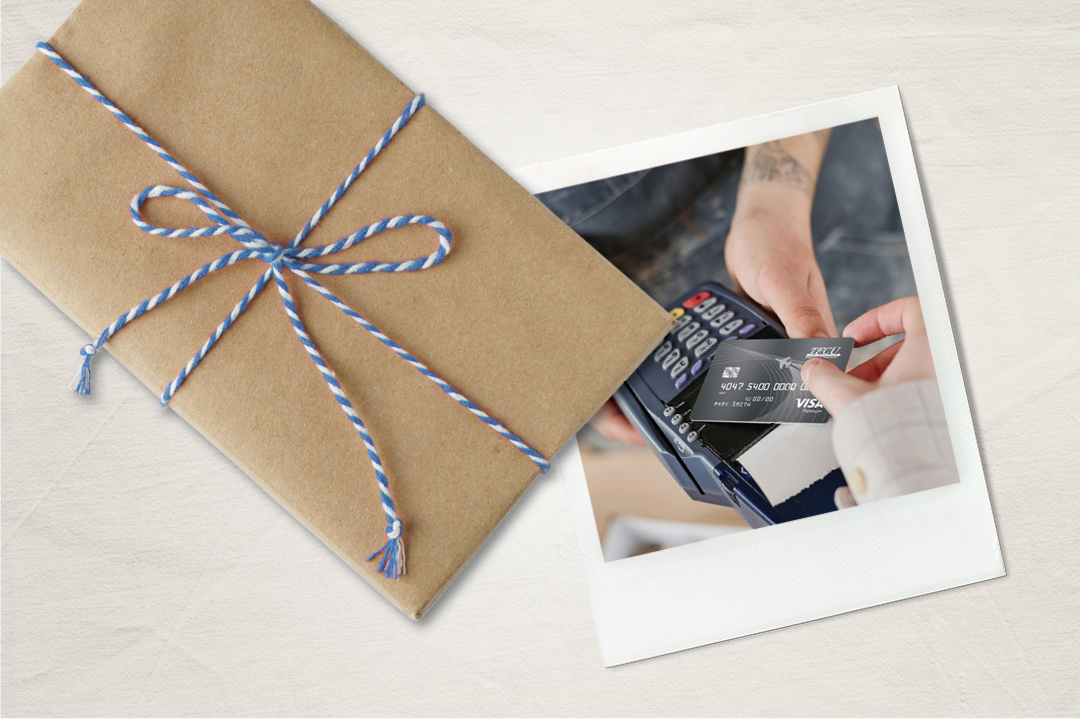 A present with a polaroid of someone paying with a credit card.