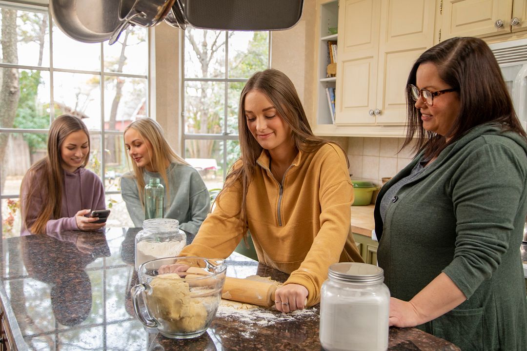 A mom and daughters family cooking in the kitchen