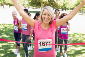 Woman in pink crossing a finish line